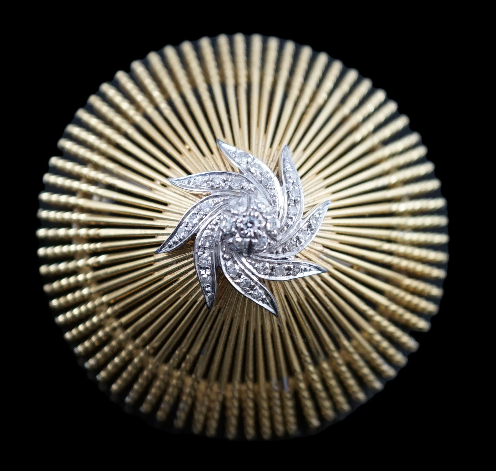 A modern stylish Italian pierced 18k and diamond chip set domed brooch